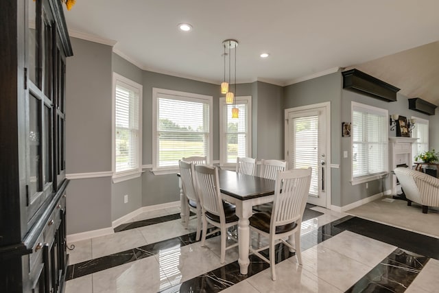 dining room featuring a wealth of natural light, ornamental molding, and light tile patterned floors