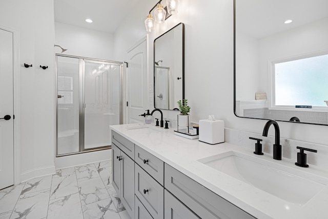 bathroom featuring tile patterned floors, a shower with door, and vanity