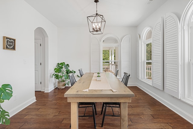 dining room featuring dark wood-type flooring and a chandelier