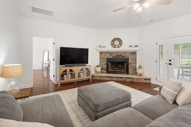 living room with ceiling fan, a fireplace, and dark hardwood / wood-style floors