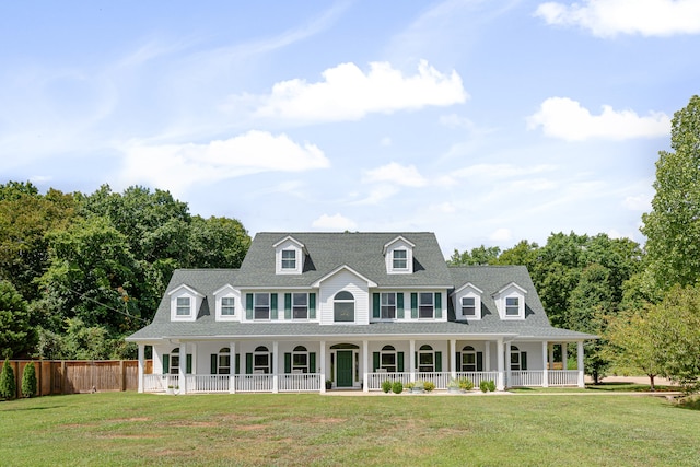 cape cod home with covered porch and a front lawn