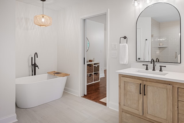 bathroom with tile patterned flooring, shower with separate bathtub, and vanity