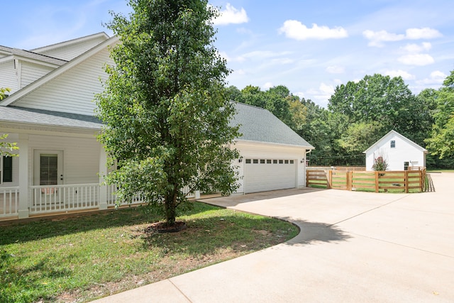 view of front of home featuring a garage, a front lawn, and a porch