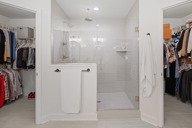 bathroom featuring tile patterned flooring and an enclosed shower