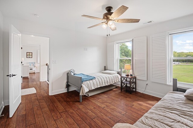 bedroom with ceiling fan and dark hardwood / wood-style floors