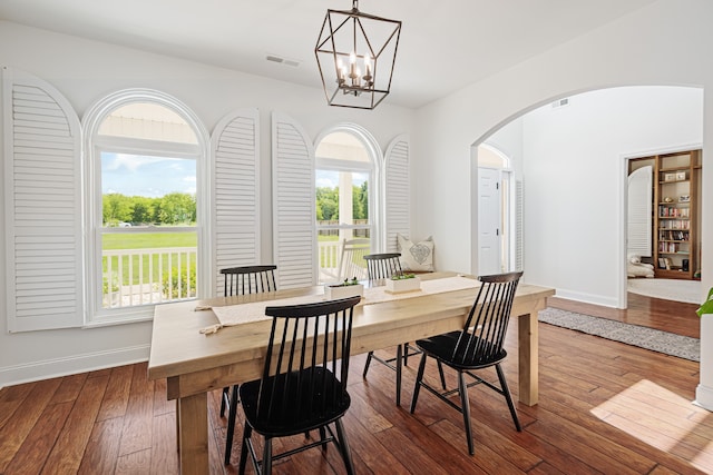 dining room featuring hardwood / wood-style flooring, plenty of natural light, and a chandelier