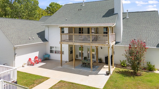 rear view of property with a patio area and a balcony