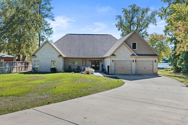 view of front of house with a front yard and a garage