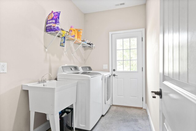 laundry room with sink and separate washer and dryer