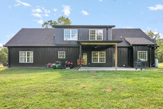 back of property featuring a patio, ceiling fan, and a lawn