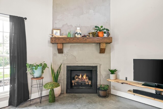 details with concrete floors and a premium fireplace