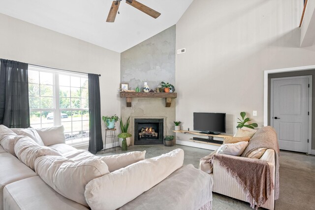 living room featuring ceiling fan, a fireplace, and high vaulted ceiling