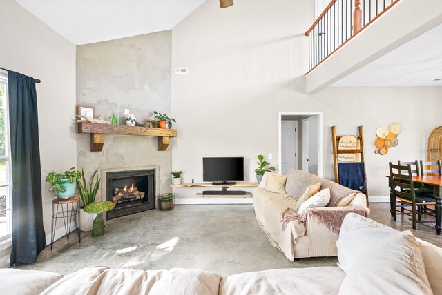 living room with a fireplace and lofted ceiling with beams