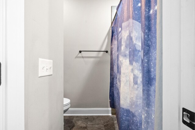 bathroom with toilet and tile patterned floors