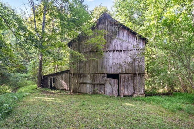 view of outbuilding with a lawn