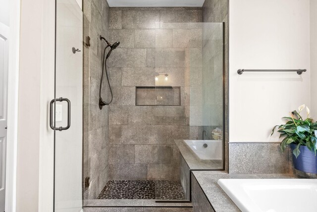 bathroom with shower with separate bathtub