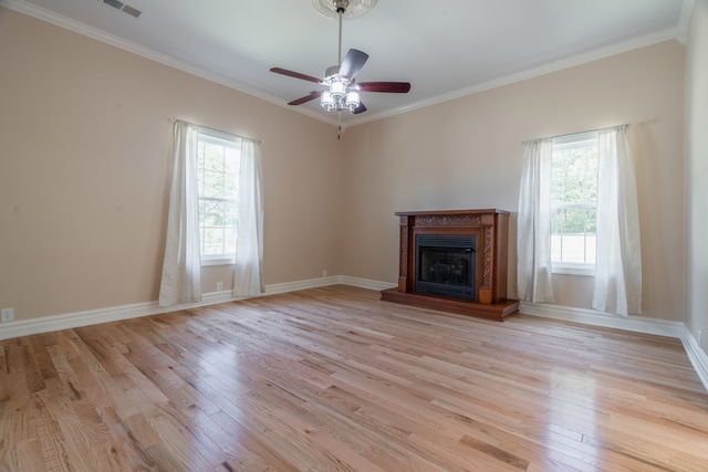 unfurnished living room with ceiling fan, light wood-type flooring, and ornamental molding