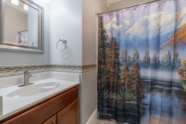 bathroom with ornamental molding and vanity