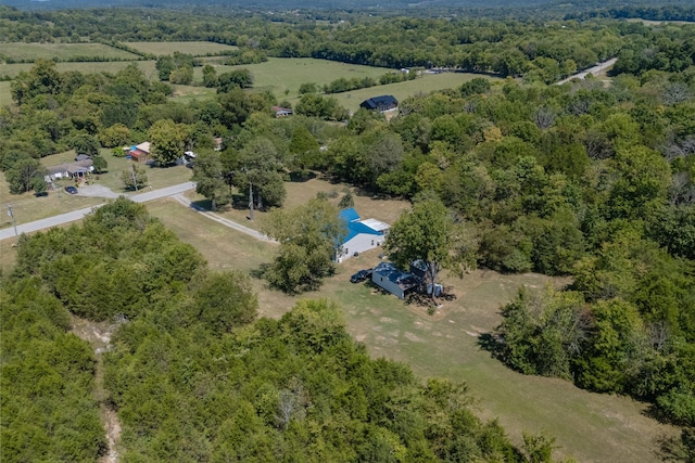 birds eye view of property featuring a view of trees