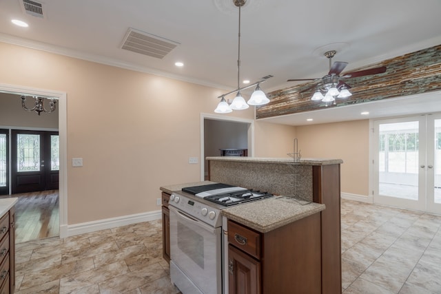 kitchen with light tile patterned floors, pendant lighting, white range oven, and ceiling fan