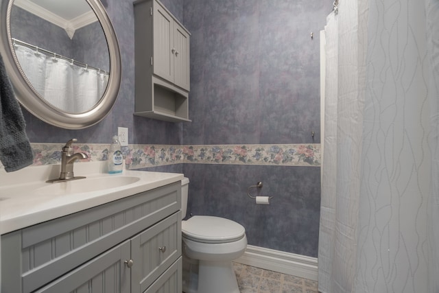 bathroom with toilet, crown molding, vanity, and tile patterned floors