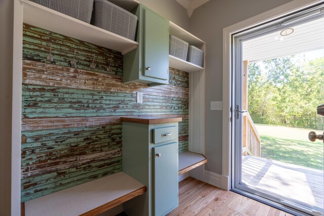 mudroom with a wealth of natural light and light hardwood / wood-style floors