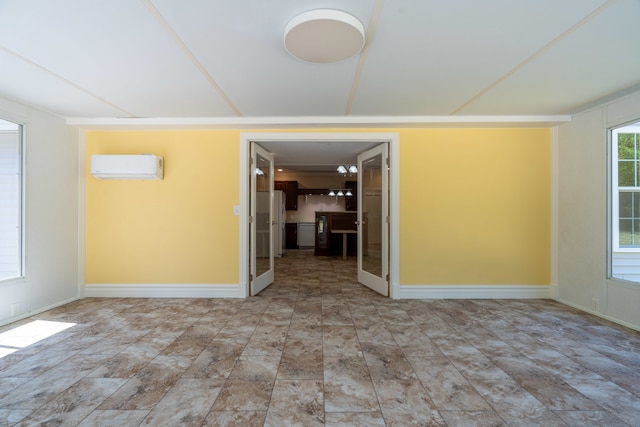 unfurnished room featuring a wall mounted AC and tile patterned floors