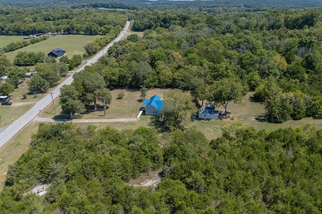 drone / aerial view featuring a wooded view