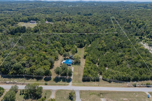 birds eye view of property featuring a view of trees