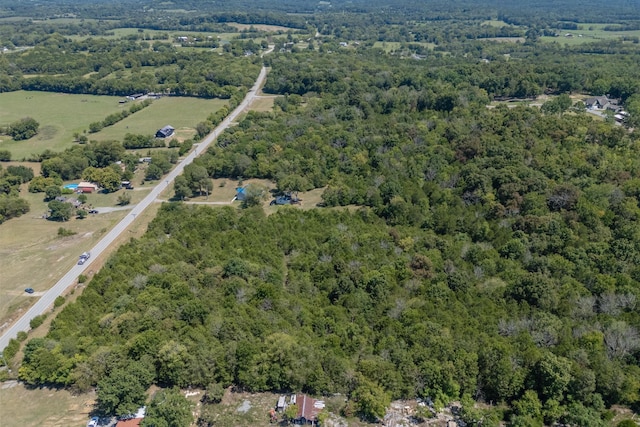 birds eye view of property featuring a view of trees