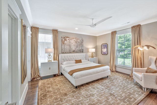 bedroom with ornamental molding, hardwood / wood-style floors, and ceiling fan