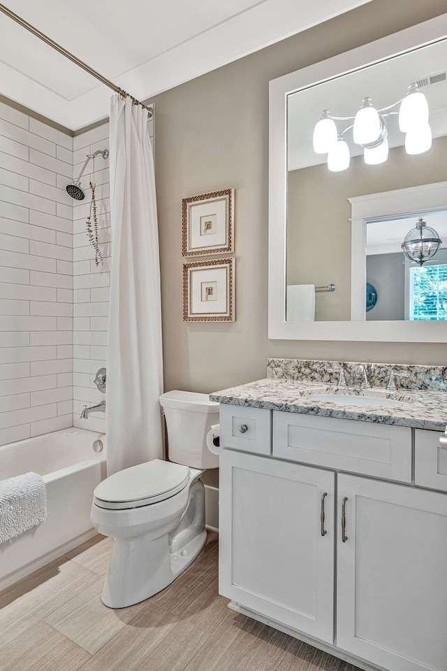 full bathroom featuring shower / bath combo, hardwood / wood-style floors, toilet, and vanity