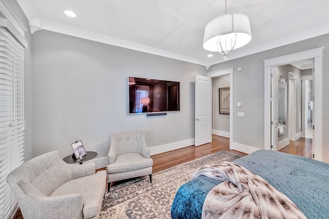 bedroom with crown molding and hardwood / wood-style floors