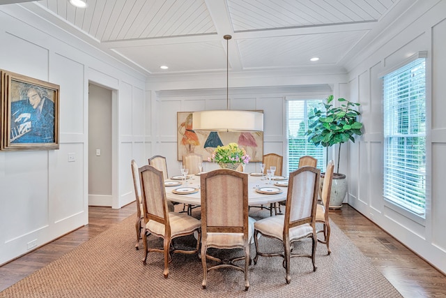 dining area featuring a wealth of natural light, crown molding, and hardwood / wood-style floors