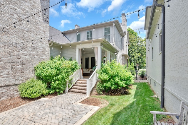 view of front of home with a front yard and covered porch