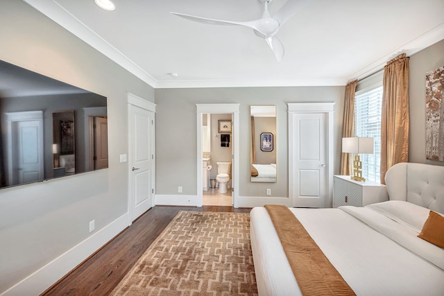 bedroom with ceiling fan, dark hardwood / wood-style floors, connected bathroom, and ornamental molding