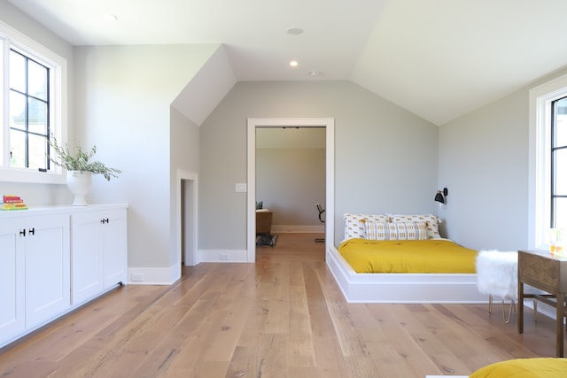 interior space with vaulted ceiling and light wood-type flooring