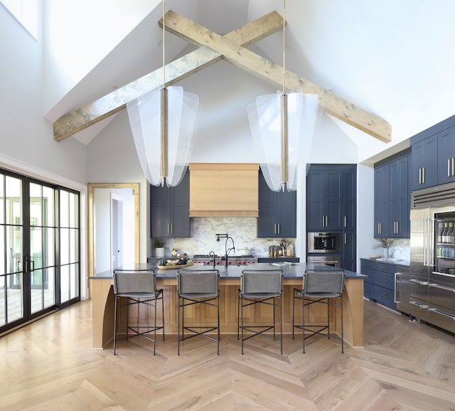 kitchen with decorative backsplash, sink, beamed ceiling, light parquet flooring, and a breakfast bar