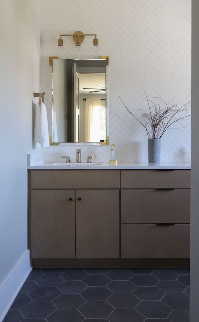 bathroom featuring backsplash, tile patterned flooring, and vanity