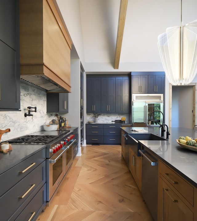 kitchen featuring decorative backsplash, light parquet flooring, custom range hood, and premium appliances