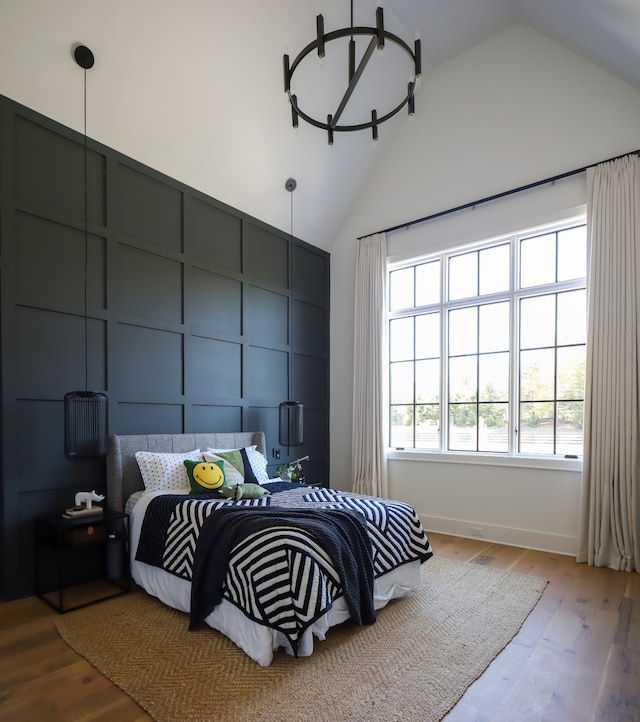 bedroom featuring vaulted ceiling and light hardwood / wood-style floors