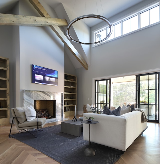 living room with parquet floors, high vaulted ceiling, built in features, beam ceiling, and a premium fireplace