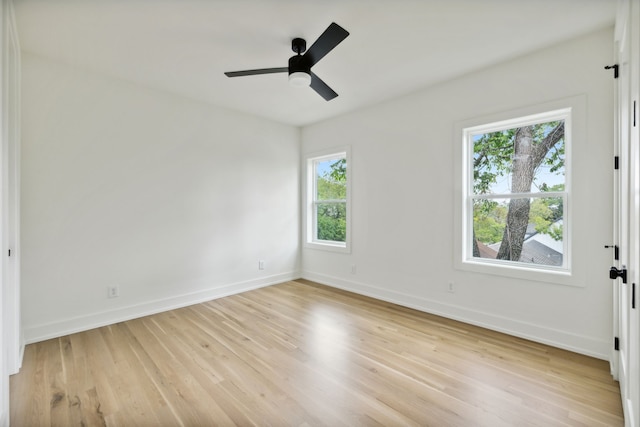 empty room featuring light wood-type flooring and ceiling fan