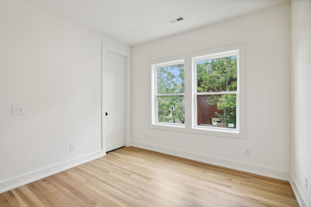 spare room featuring light hardwood / wood-style floors