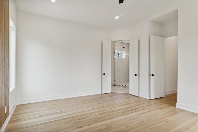 unfurnished bedroom featuring ceiling fan and light wood-type flooring