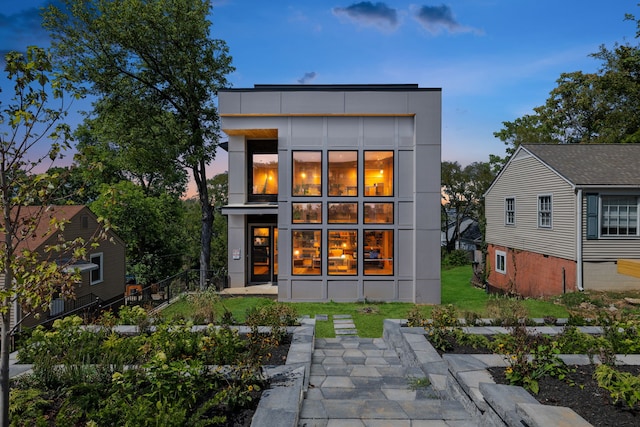 view of back house at dusk