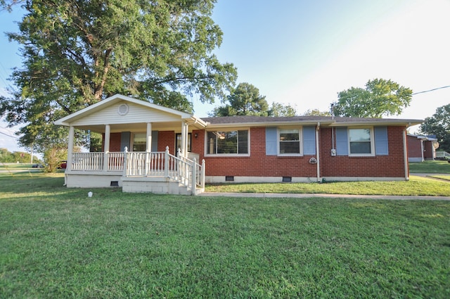 ranch-style house featuring a front lawn and covered porch