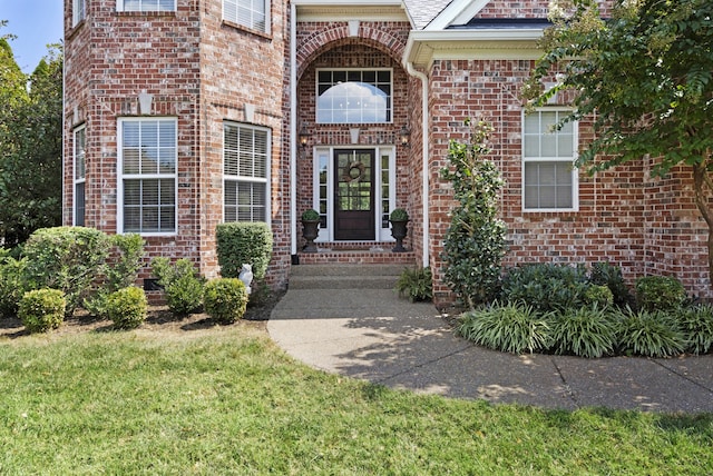 entrance to property with a lawn