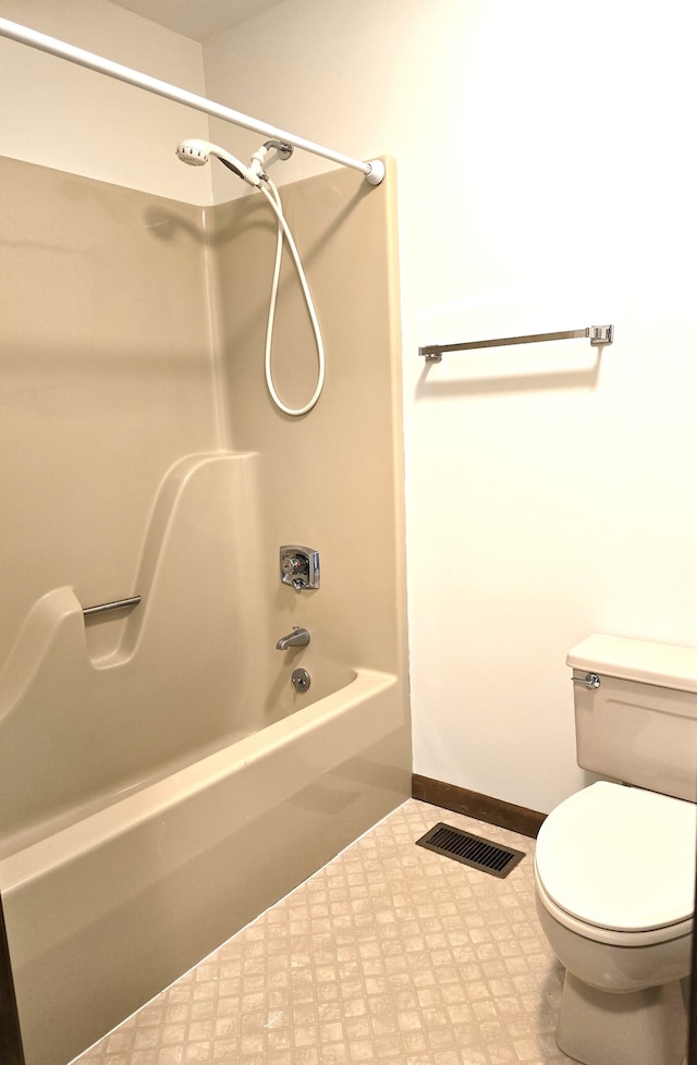 bathroom featuring shower / bathtub combination and toilet