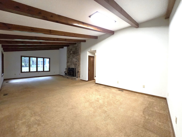 unfurnished living room with vaulted ceiling with beams, carpet, and a fireplace